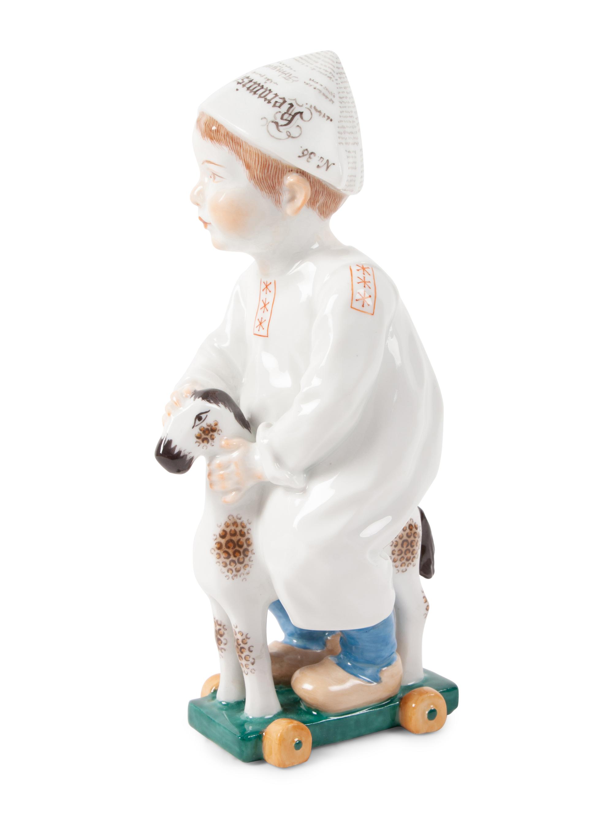 A Meissen Porcelain Figure of a Boy on a Pull Toy, by Konrad Hentschel