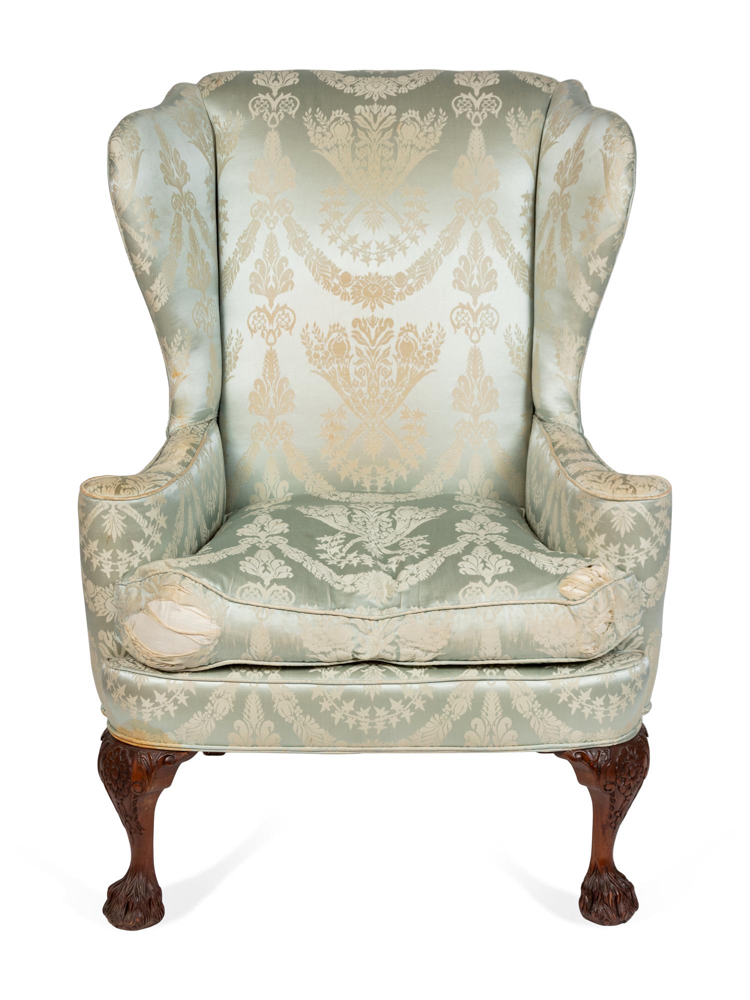 A George II Style Upholstered and Carved Mahogany Wing Armchair