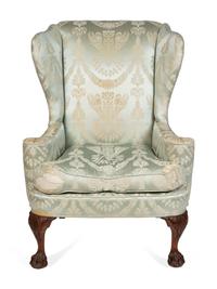 A George II Style Upholstered and Carved Mahogany Wing Armchair