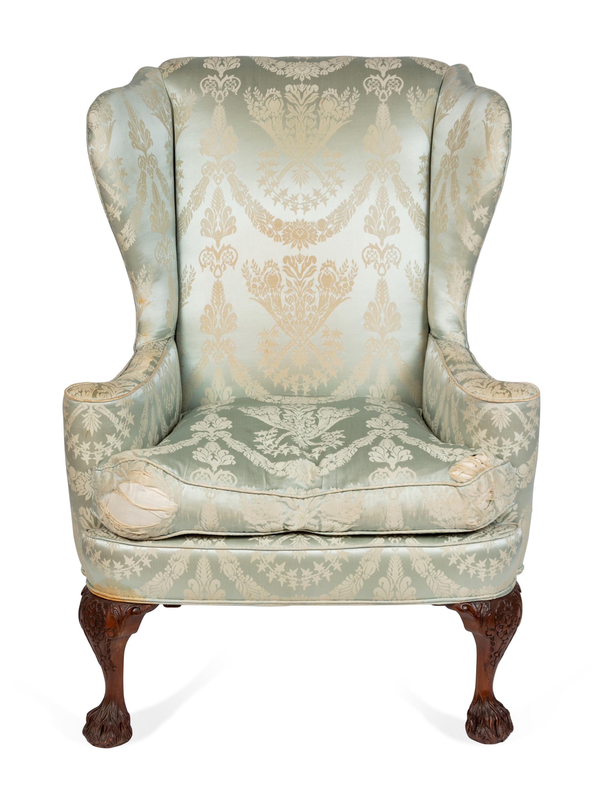 A George II Style Upholstered and Carved Mahogany Wing Armchair