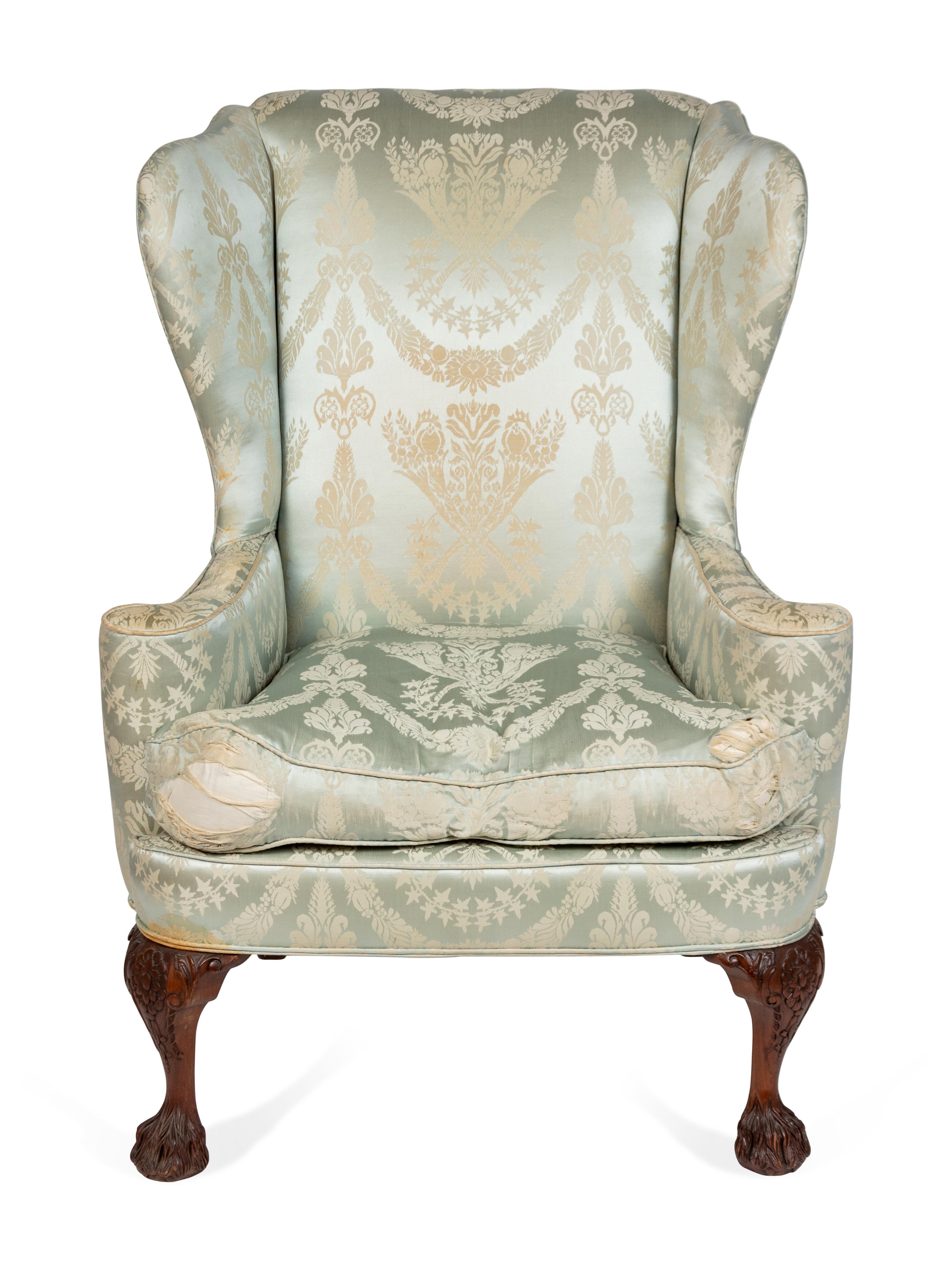A George II Style Upholstered and Carved Mahogany Wing Armchair