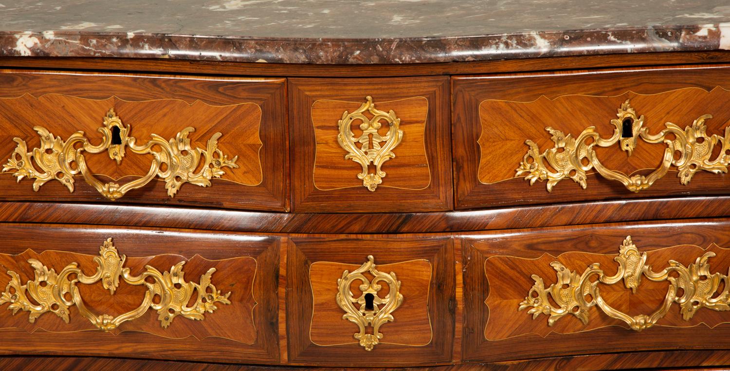 A Louis XV Gilt Bronze Mounted Kingwood and Tulipwood Marble Top Bombé Commode