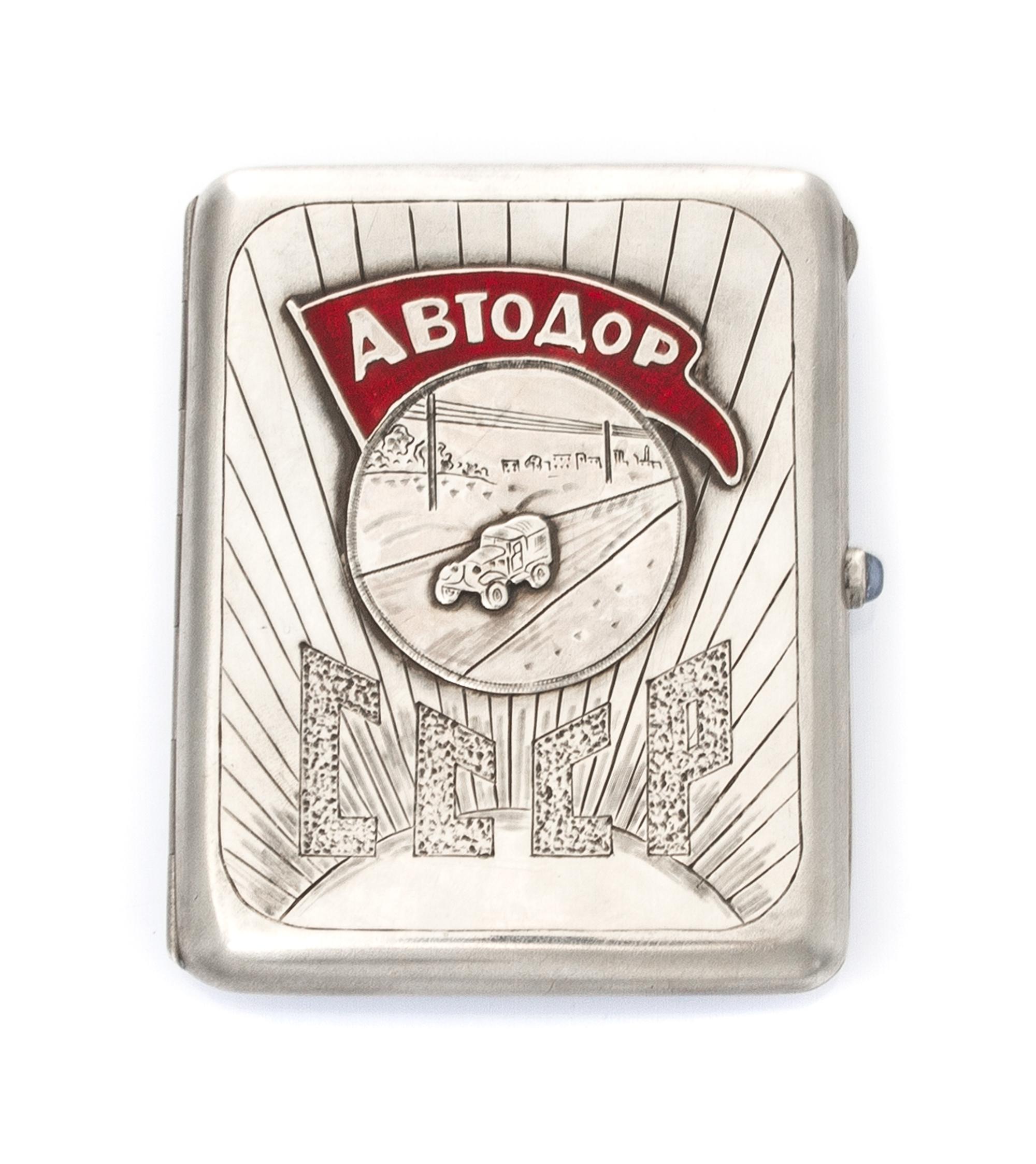 A Russian Silver and Enamel Cigarette Case, Maker's mark AO, of rectangular form, the lid centered by an applied roundel decorated with