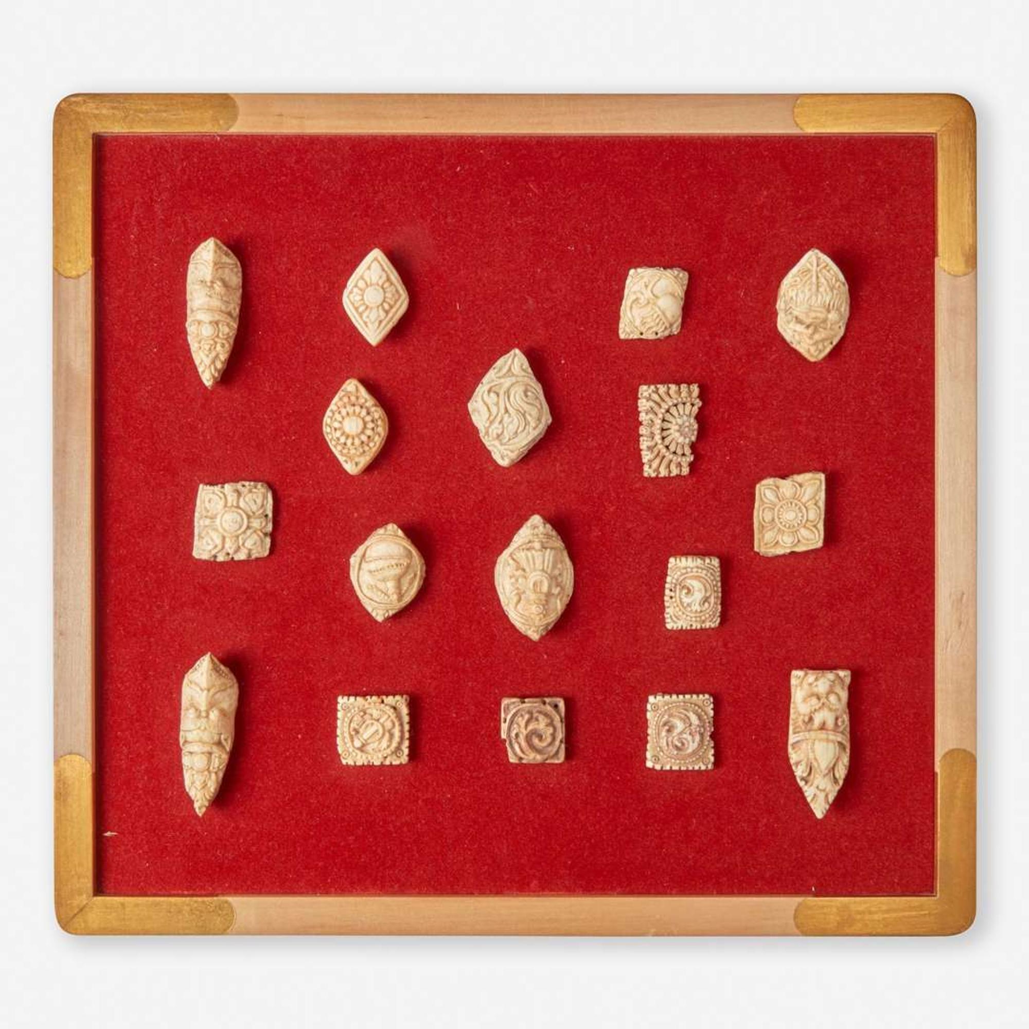 Two framed collections of Tibetan carved bone apron ornaments 藏传佛教法衣骨片两套