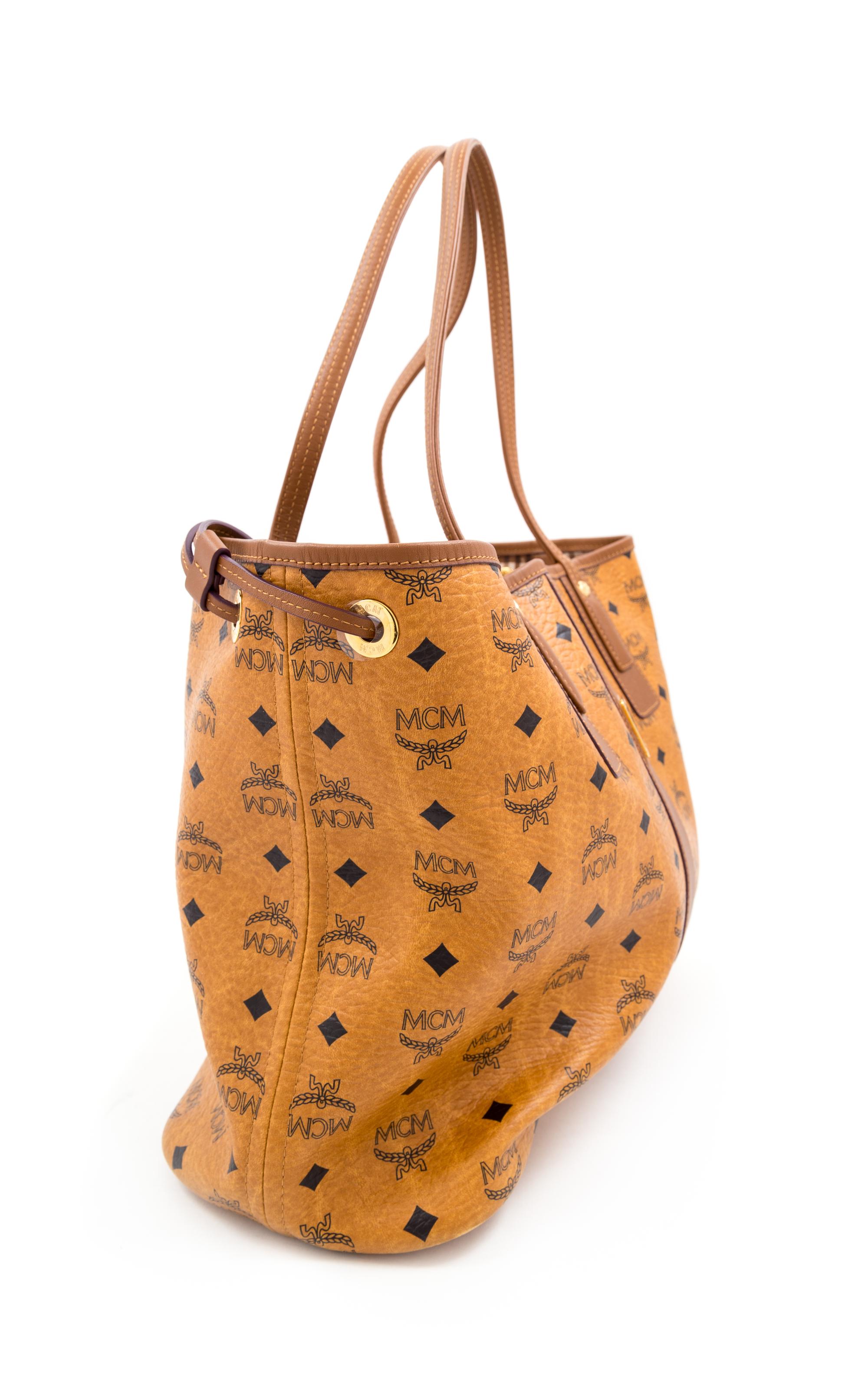An MCM Cognac Reversible Liz Visetos Shopper Tote, 12" H x 13" W x 6" D; Strap drop: 8.75".