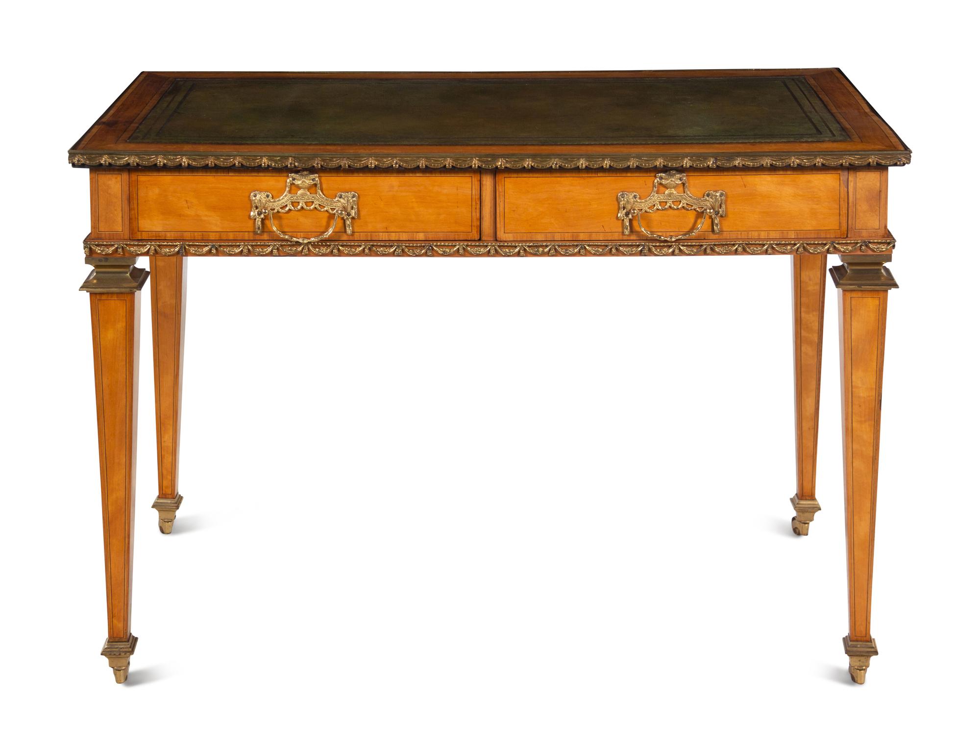 An English Gilt Bronze Mounted Satinwood Writing Table in the Louis XVI Taste