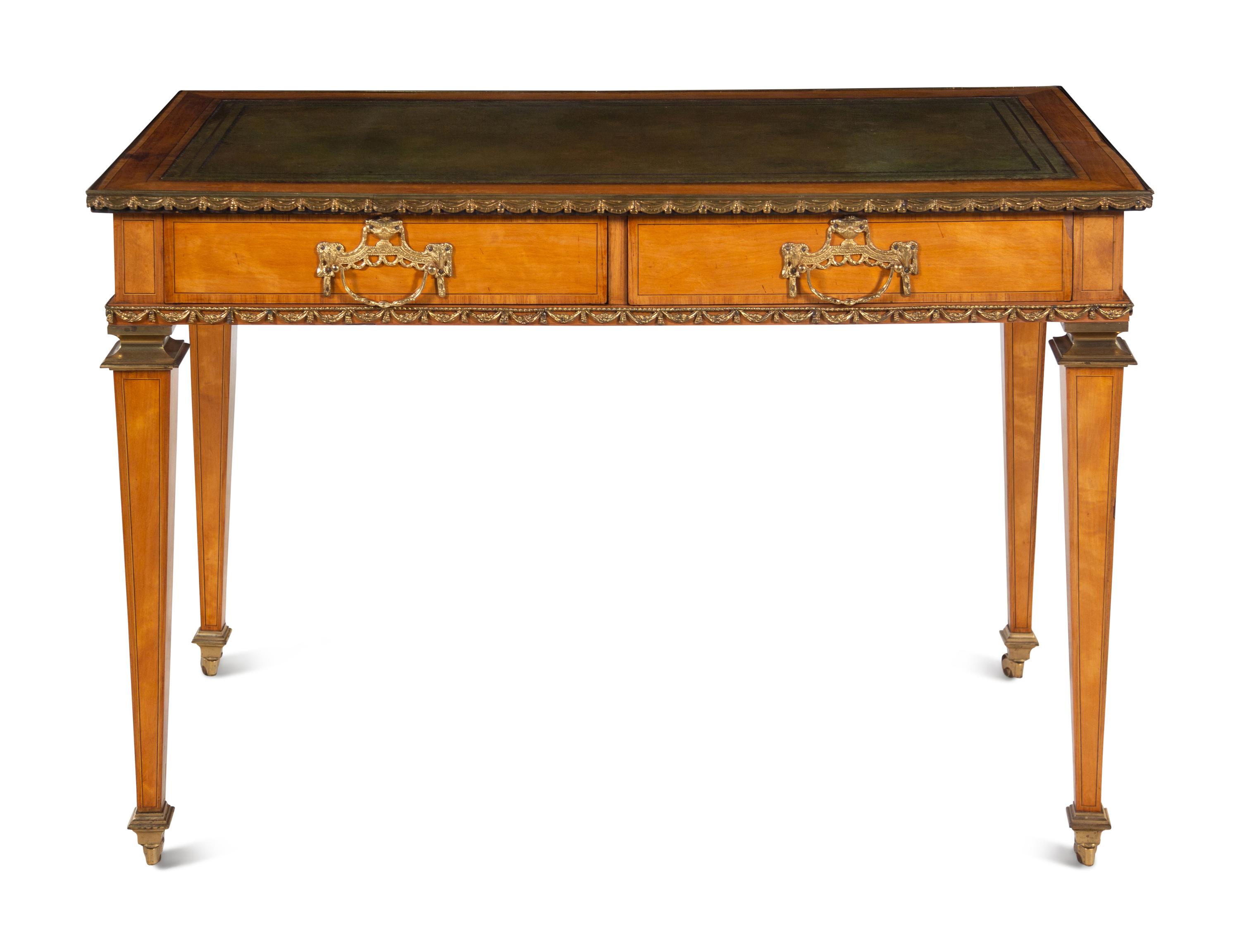 An English Gilt Bronze Mounted Satinwood Writing Table in the Louis XVI Taste