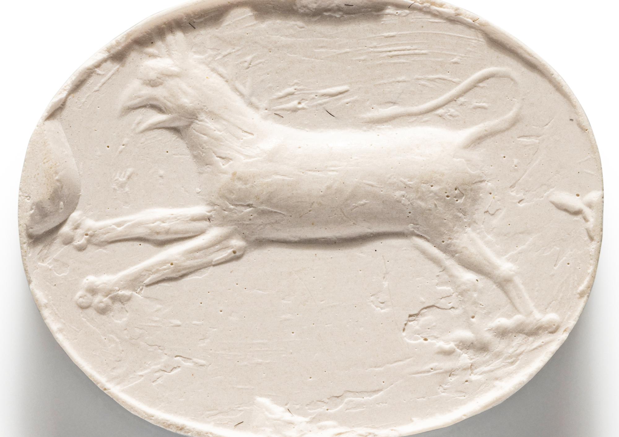A Greco-Persian Blue Chalcedony Scaraboid with a Leaping Griffin