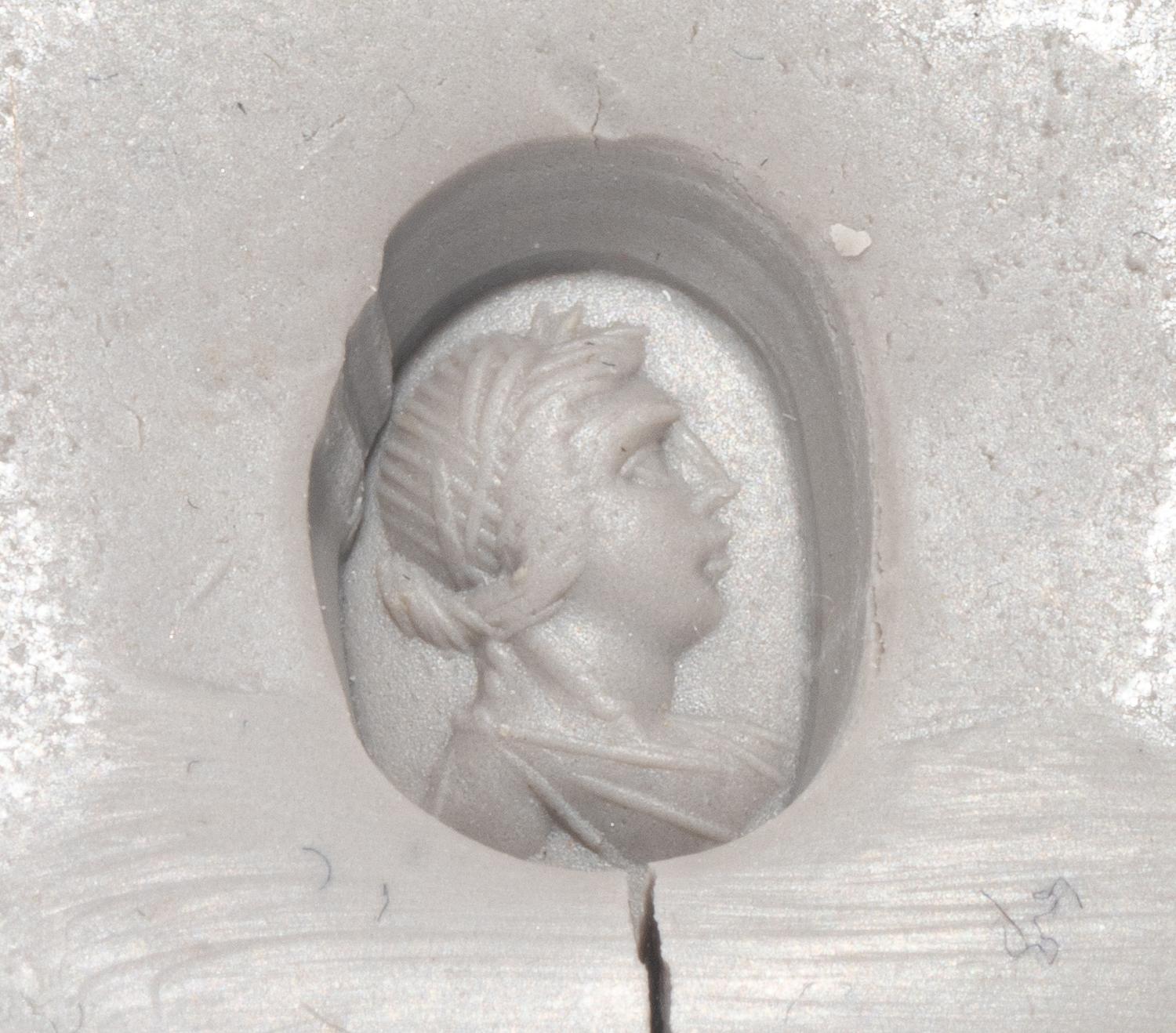 A Roman Hematite Ring Stone with a Male Portrait Head, Possibly the God Apollo