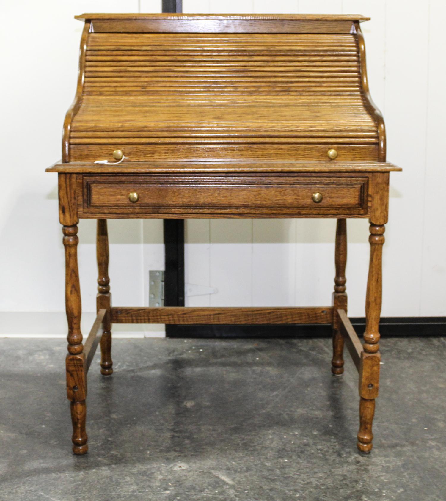 A Roll Top Desk. Height 44 1/2 x width 32 1/2 x depth 24 inches.