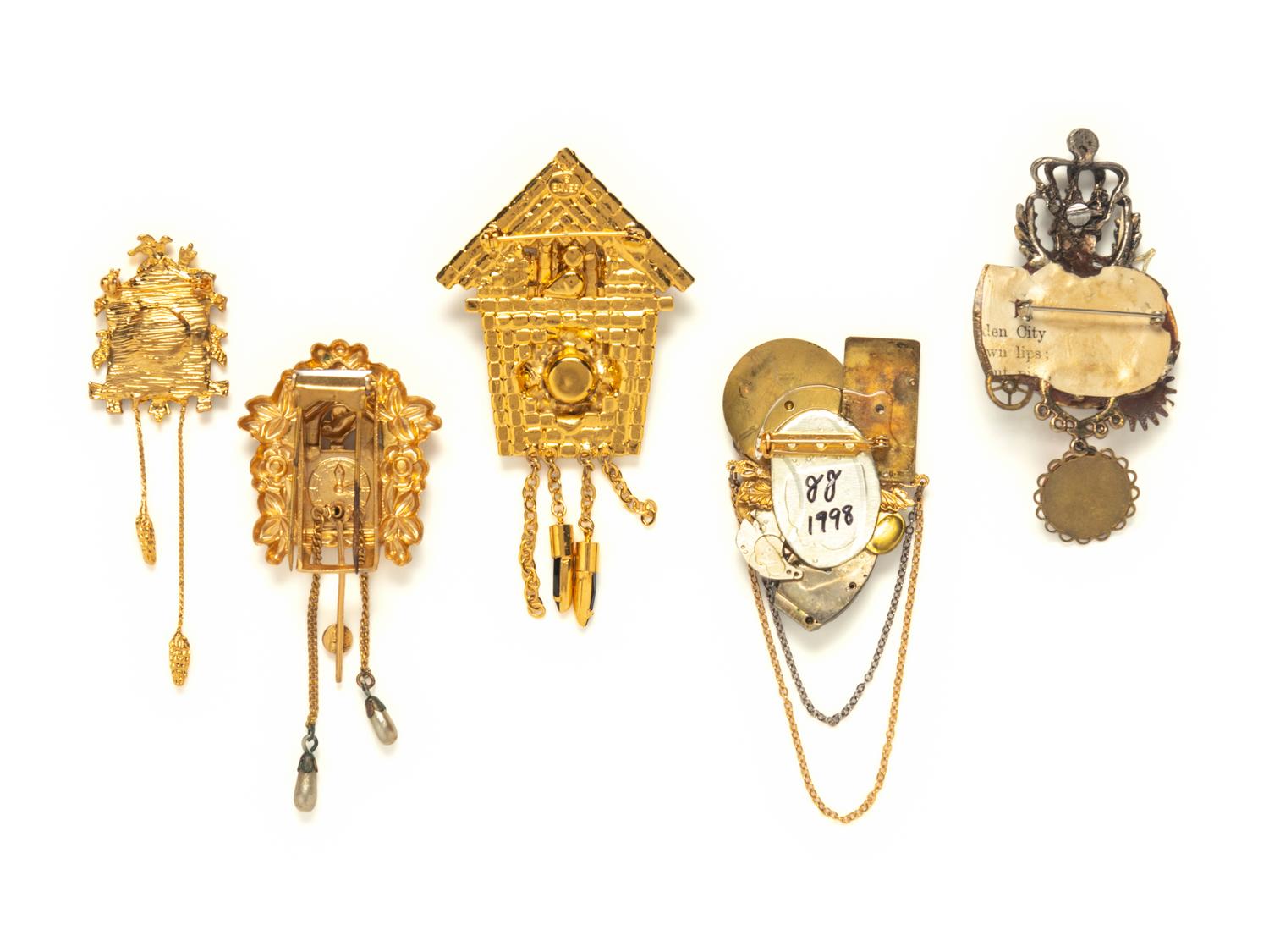 A GROUP OF FIVE TIMEPIECE THEMED BROOCHES