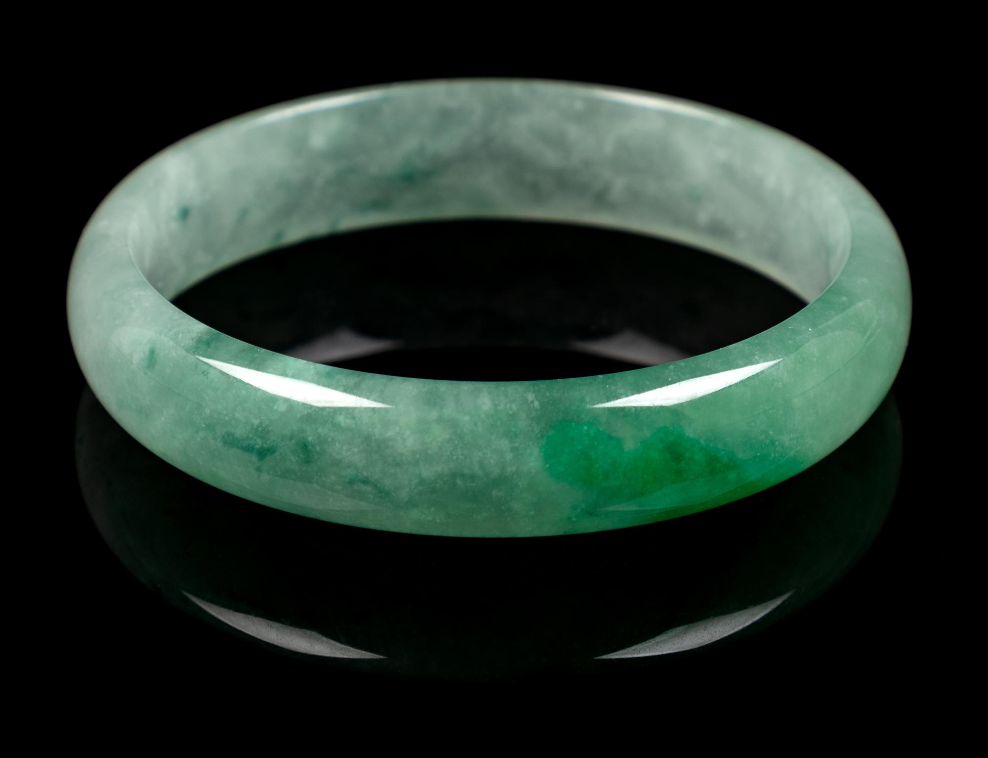 An Apple Green and Pale Celadon Jadeite Bangle