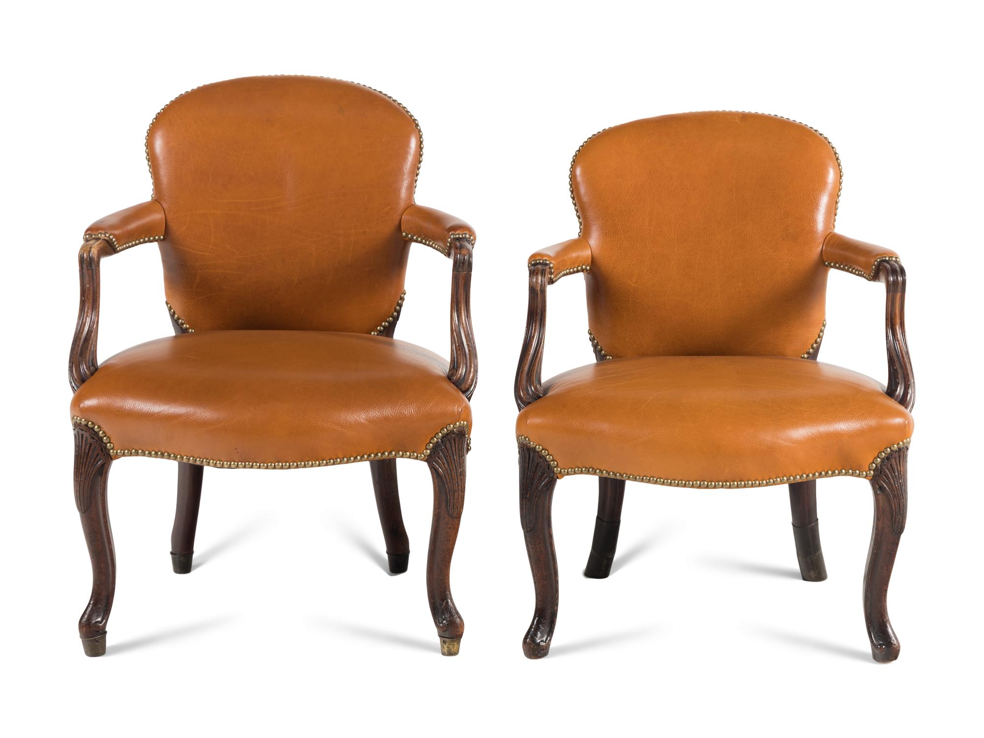 A Near Pair of George III Mahogany Leather-Upholstered Armchairs