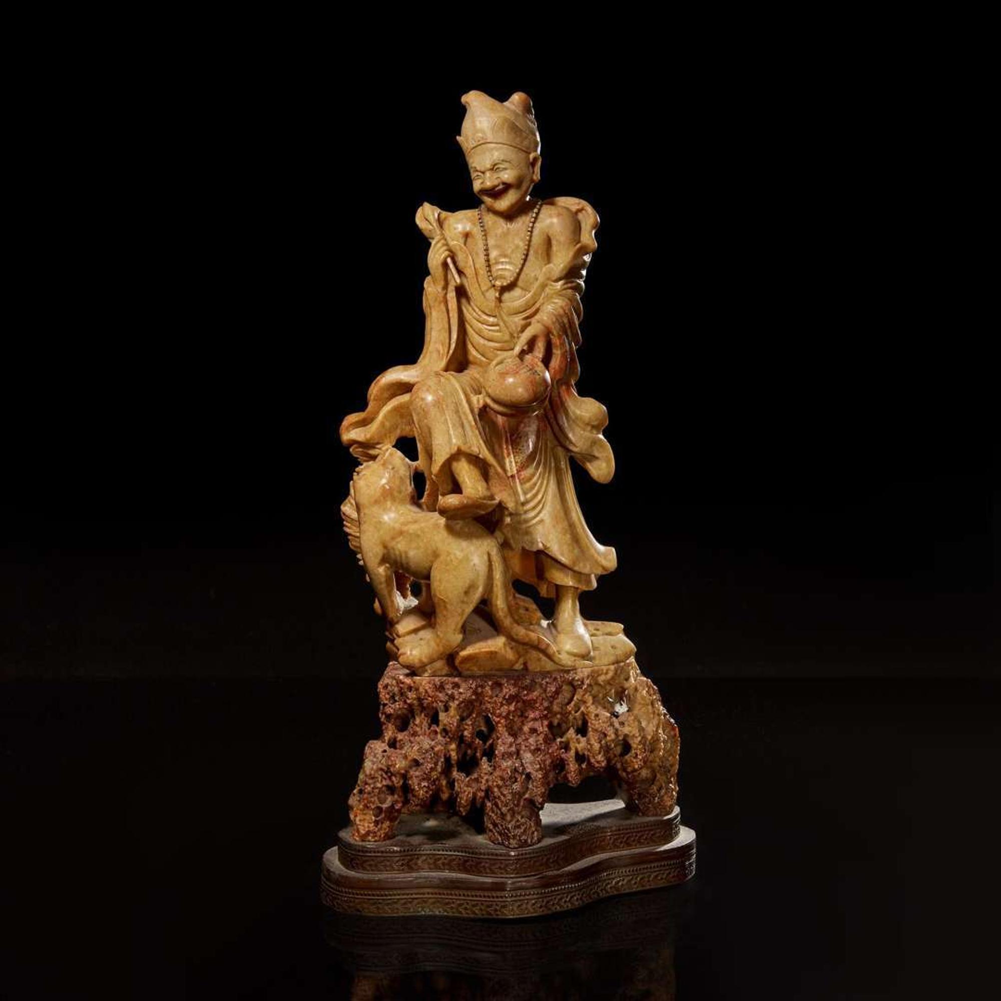 A Chinese carved beige soapstone figure of an immortal or monk with tiger 壽山石雕伏虎羅漢 Republic period or earlier ?????