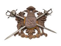 A Continental Carved Armor Trophy with Crossed Swords