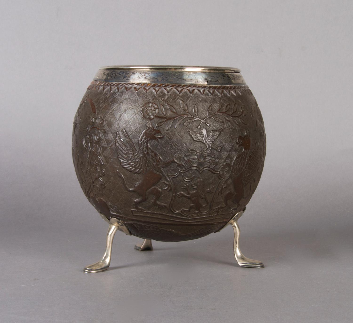 An English Carved and Silver Mounted Coconut Shell, Height 6 inches.