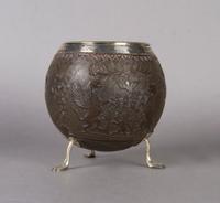 An English Carved and Silver Mounted Coconut Shell, Height 6 inches.
