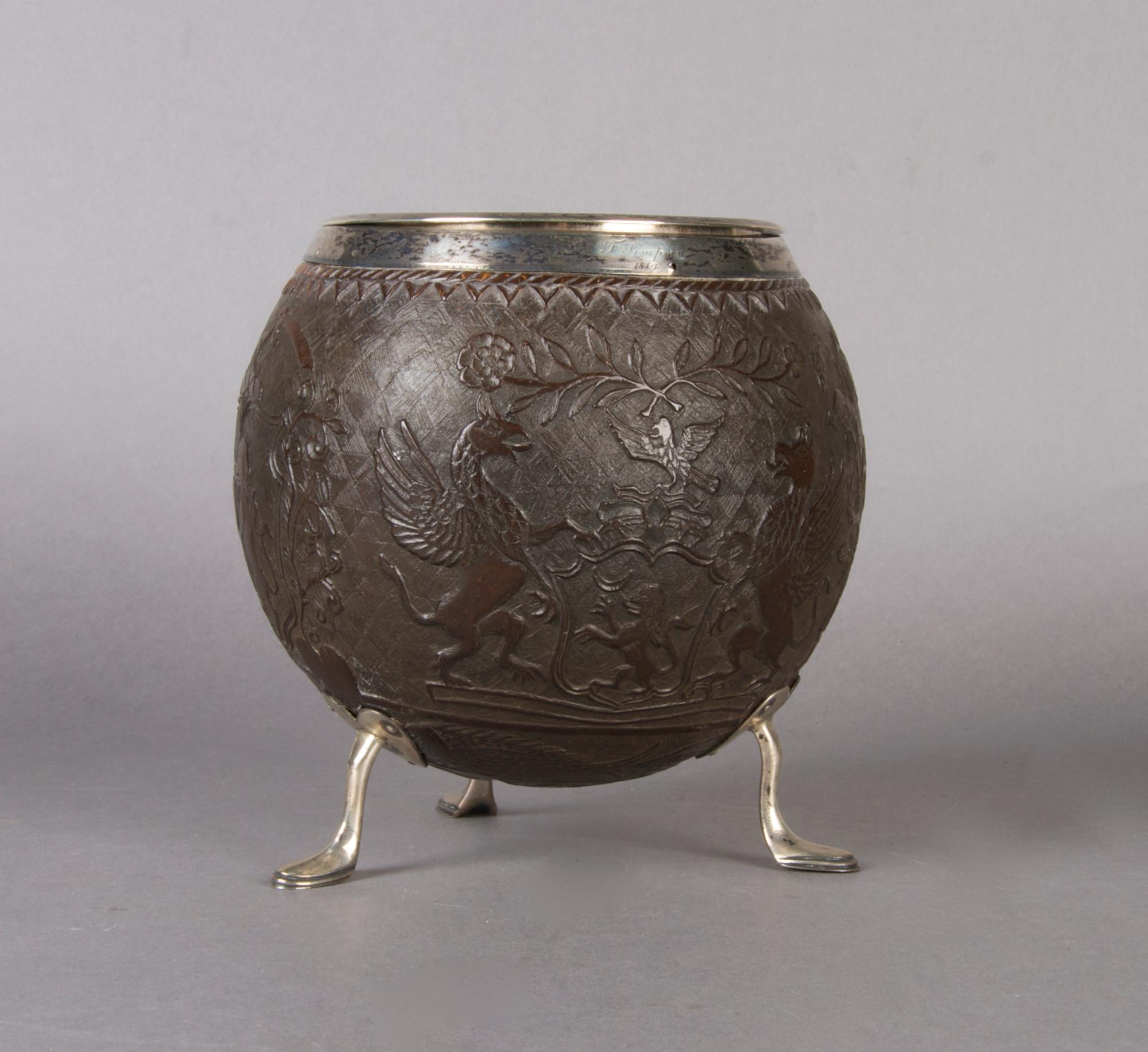 An English Carved and Silver Mounted Coconut Shell, Height 6 inches.