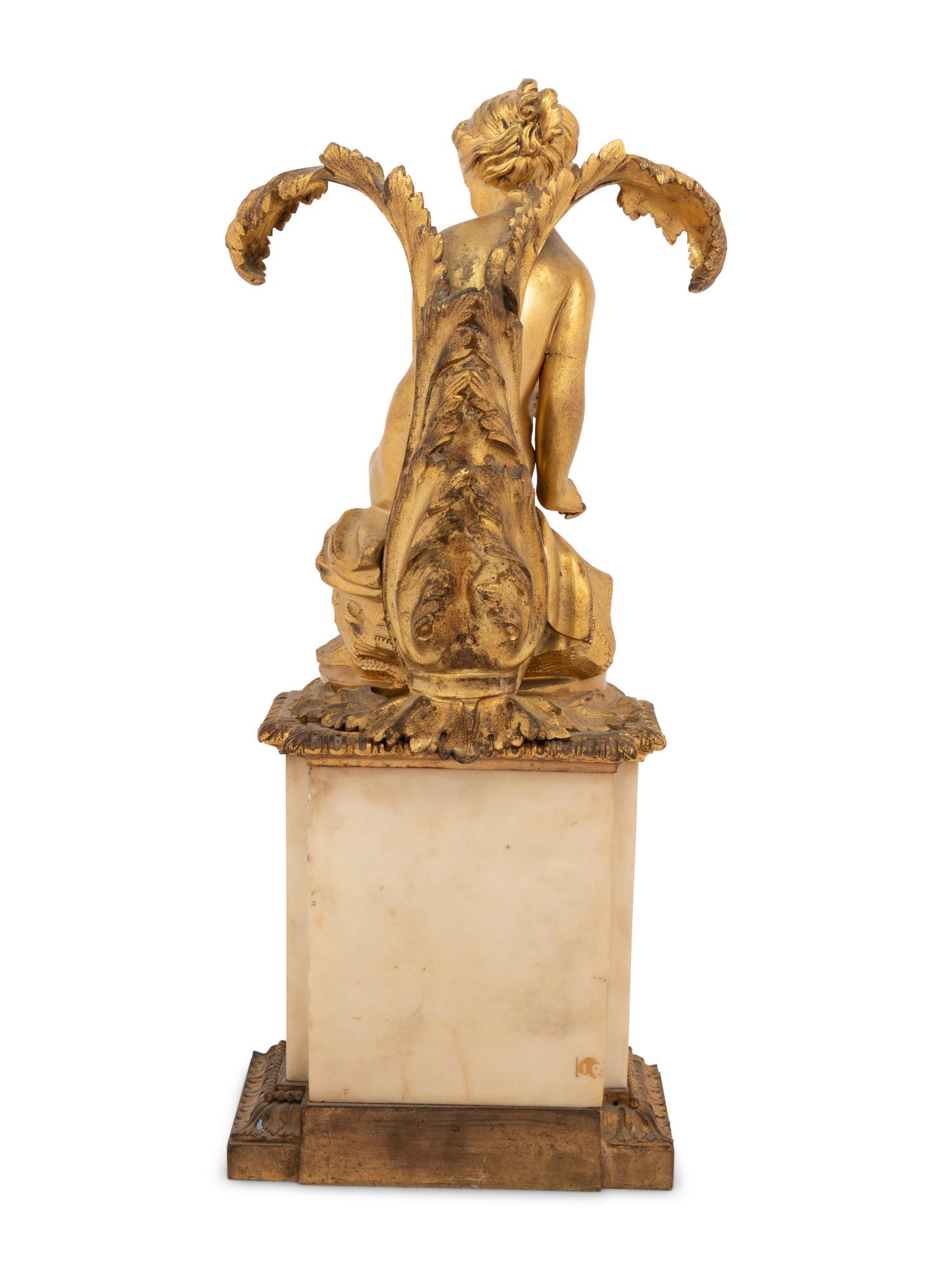 A Continental Gilt Bronze and Marble Figural Ornament