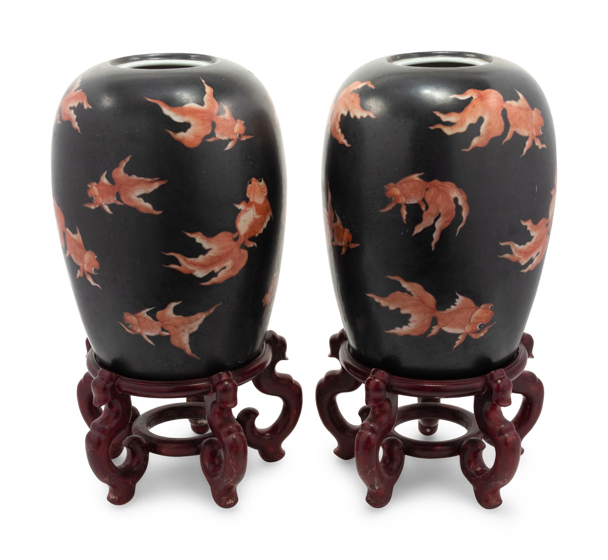 A Pair of Chinese Porcelain Goldfish Jars with Wood Stands