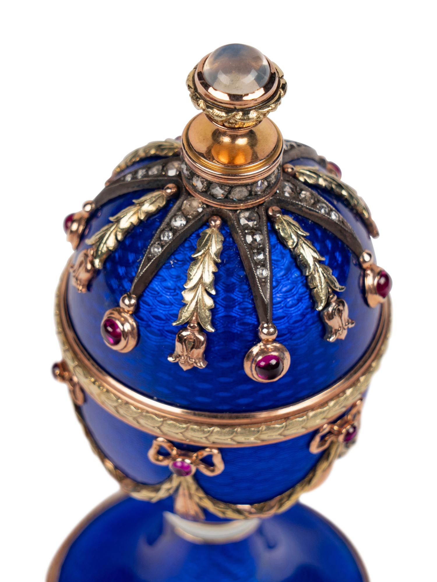 A 14 Karat Vari-Color Gold, Guilloché Enamel, Diamond, and Cabochon Jewel-Mounted Egg-Form Perfume and a Related Guilloché Enamel, 14 Karat Vari-Color Gold, Diamond, and Cabochon-Mounted Surprise Egg