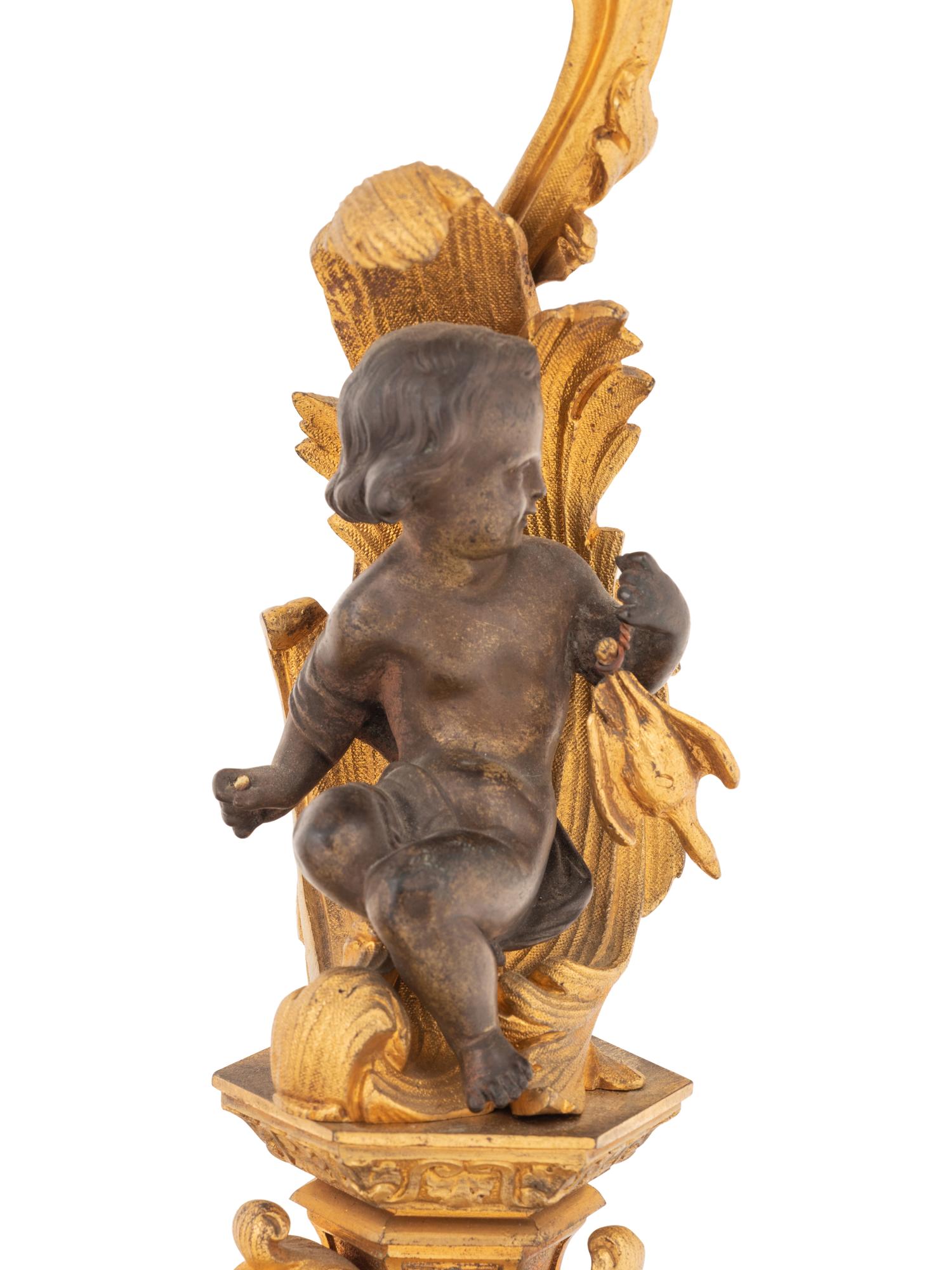 A Pair of Continental Gilt and Patinated Bronze Four-Light Candelabra