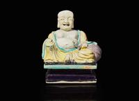 A Chinese glazed biscuit figure of Budai, Kangxi period 素三彩佈袋和尚 清康熙