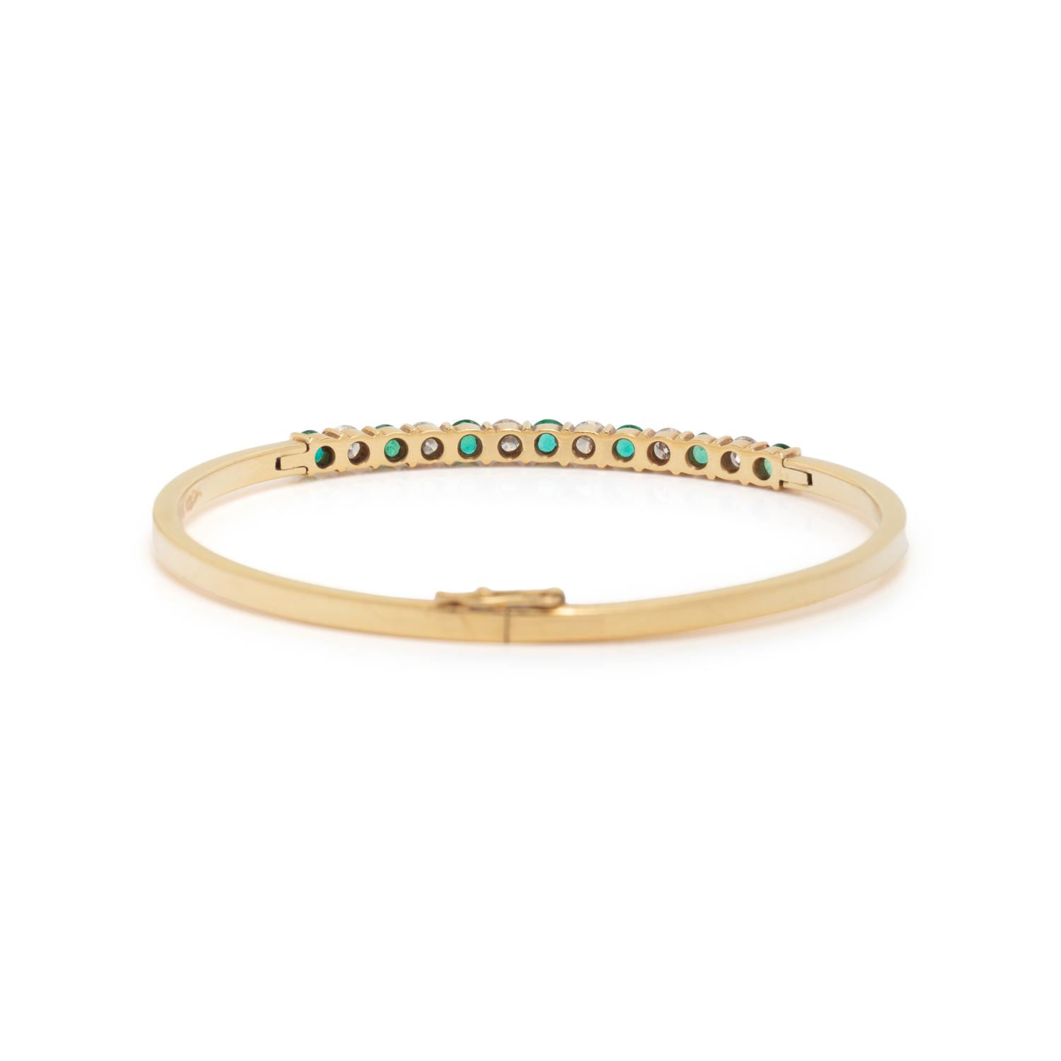 DIAMOND, EMERALD, AND YELLOW GOLD BANGLE BRACELET