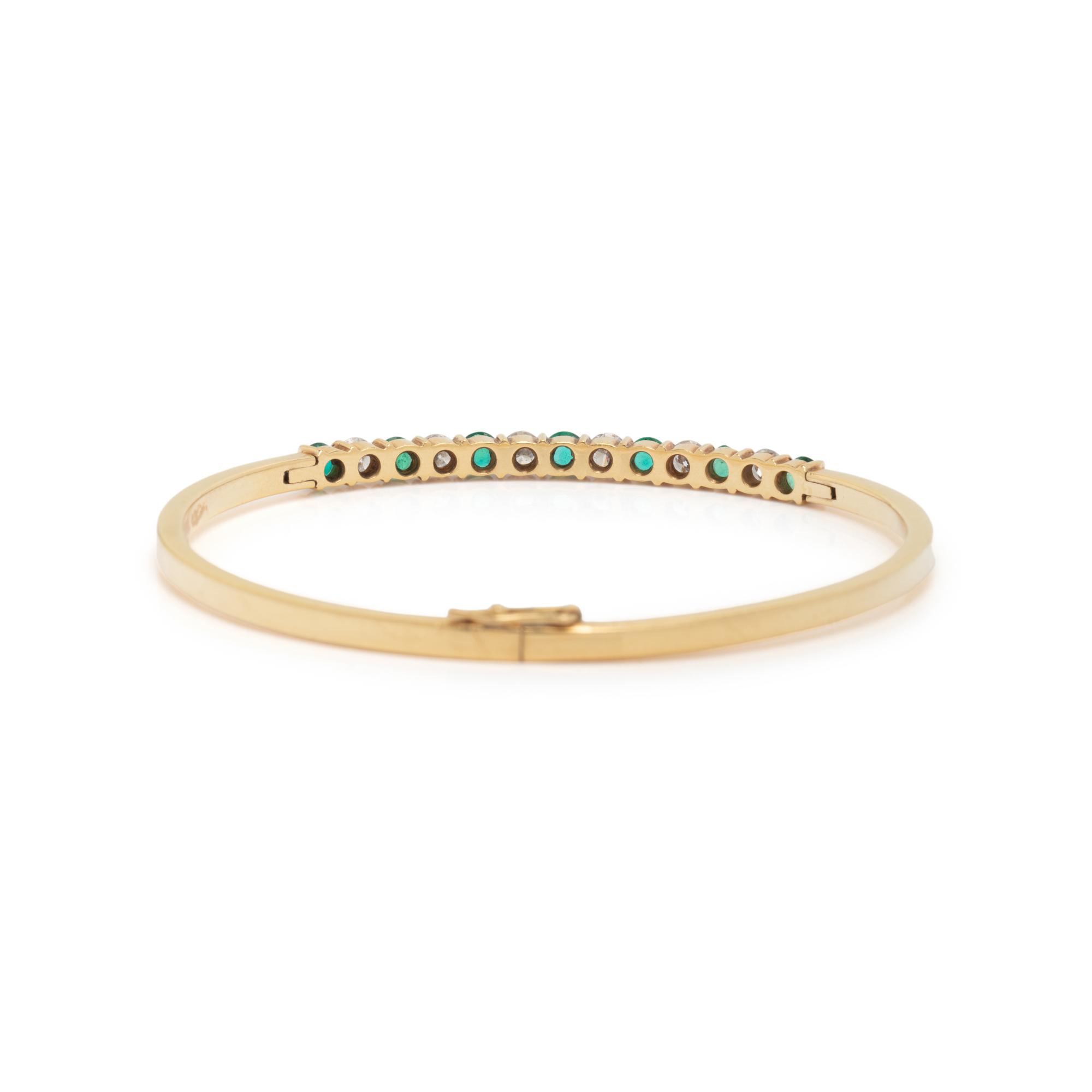 DIAMOND, EMERALD, AND YELLOW GOLD BANGLE BRACELET