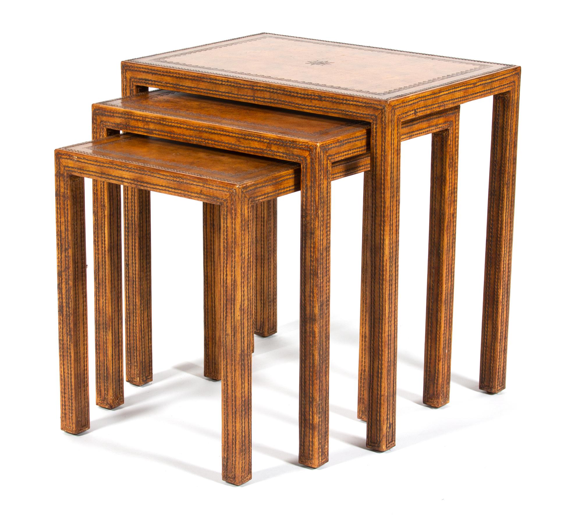 A Nest of Three Stitched Leather-Clad Tables Largest, height 22 1/4 x width 21 x depth 15 inches. — 20TH CENTURY