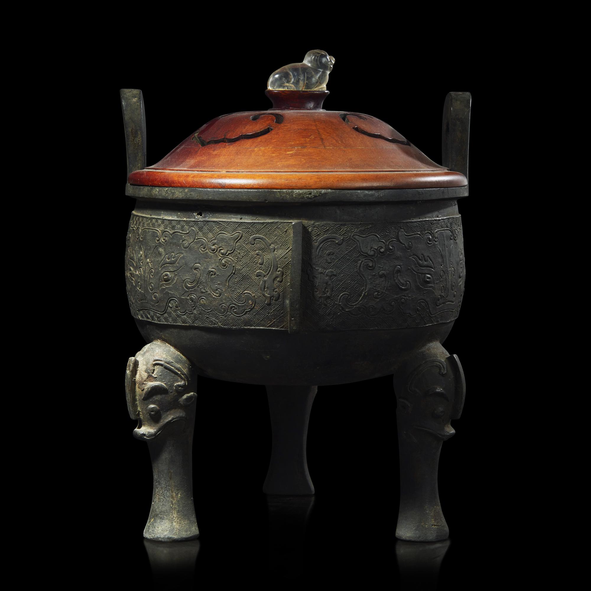 A large Chinese patinated bronze archaistic tripod censer, Ding, and wood cover, The Bronze 17th/18th Century or Earlier 清 青銅鼎式爐
