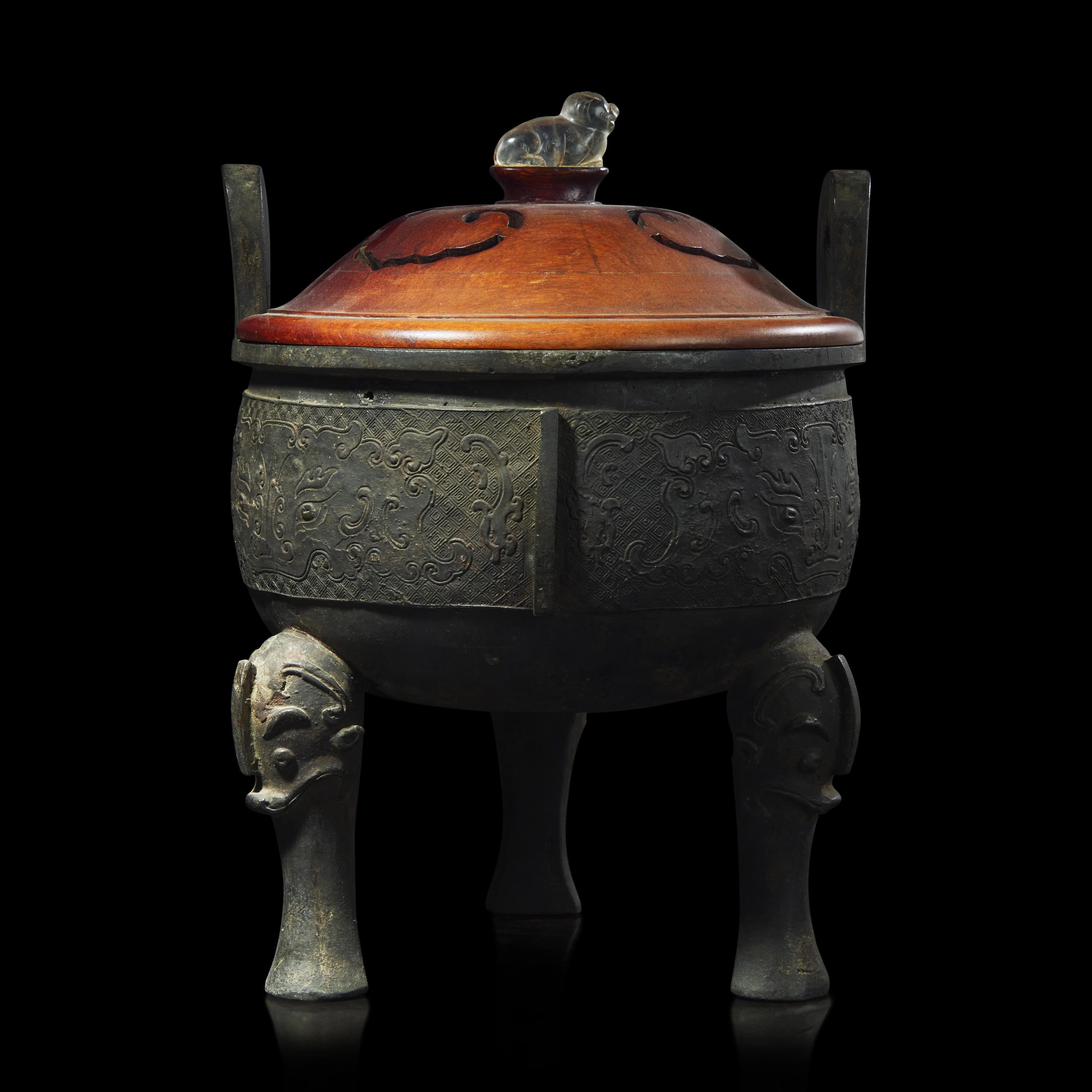 A large Chinese patinated bronze archaistic tripod censer, Ding, and wood cover, The Bronze 17th/18th Century or Earlier 清 青銅鼎式爐