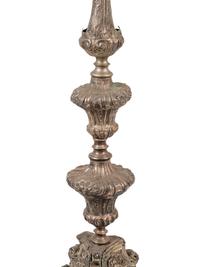 A Pair of Baroque Repoussé Decorated Silvered Metal Pricket Sticks