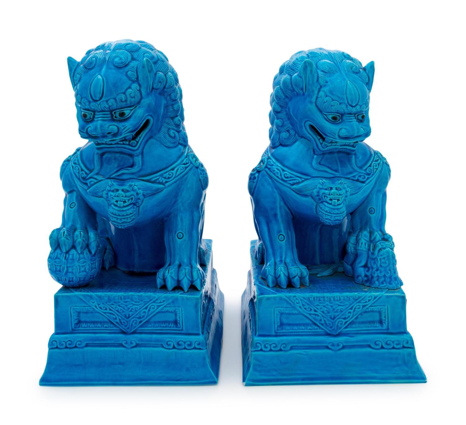 A Pair of Chinese Turquoise Glazed Porcelain Figures of Fu Lions