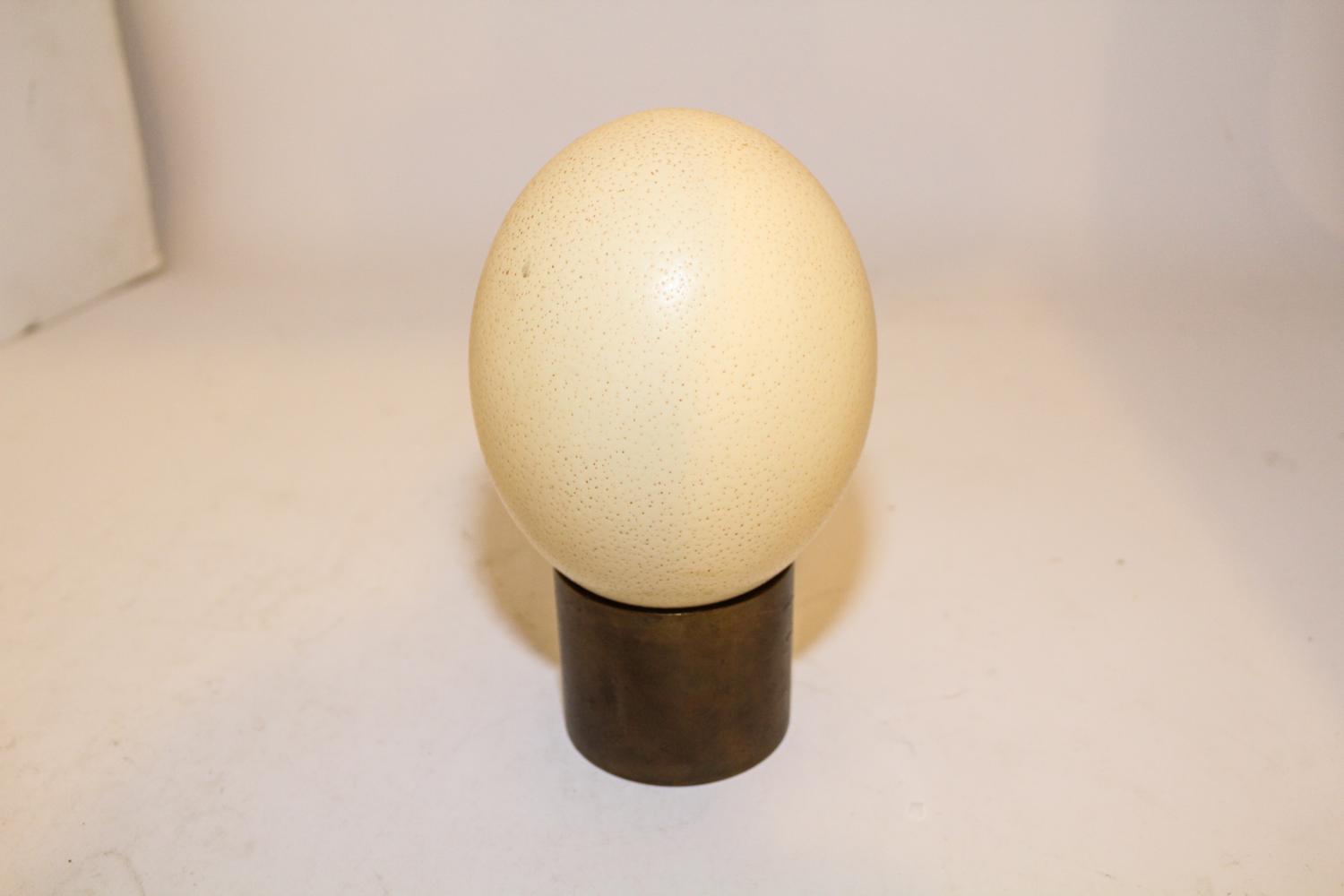 An Ostrich Egg and Associated Brass Stand Length of ostrich egg 5 3/4 inches.