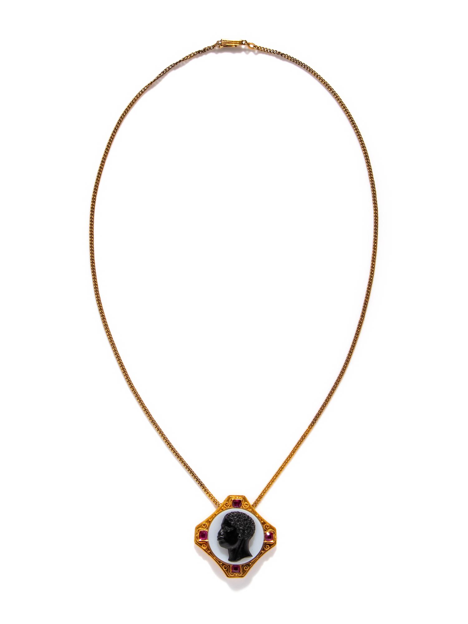 A Neoclassical Gold, Rubie, and Onyx Cameo Pendant with the Portrait Head of a Moore — with a gold chain