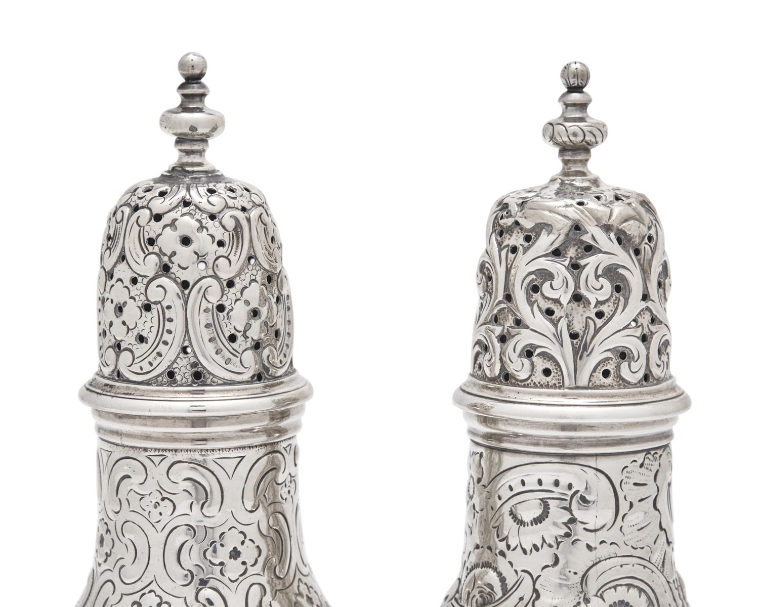 A Pair of Repousse Coin Silver Casters