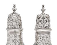 A Pair of Repousse Coin Silver Casters