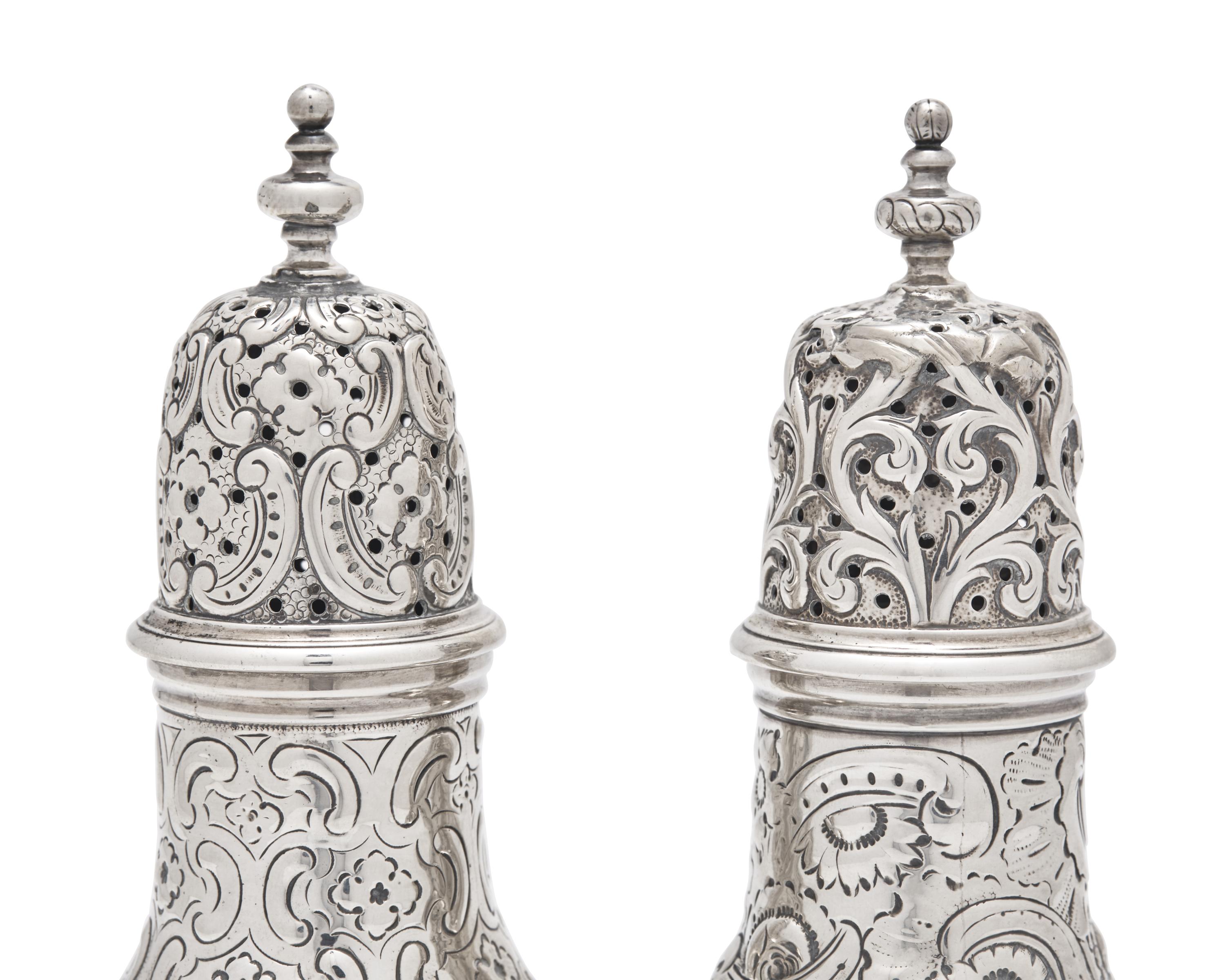 A Pair of Repousse Coin Silver Casters
