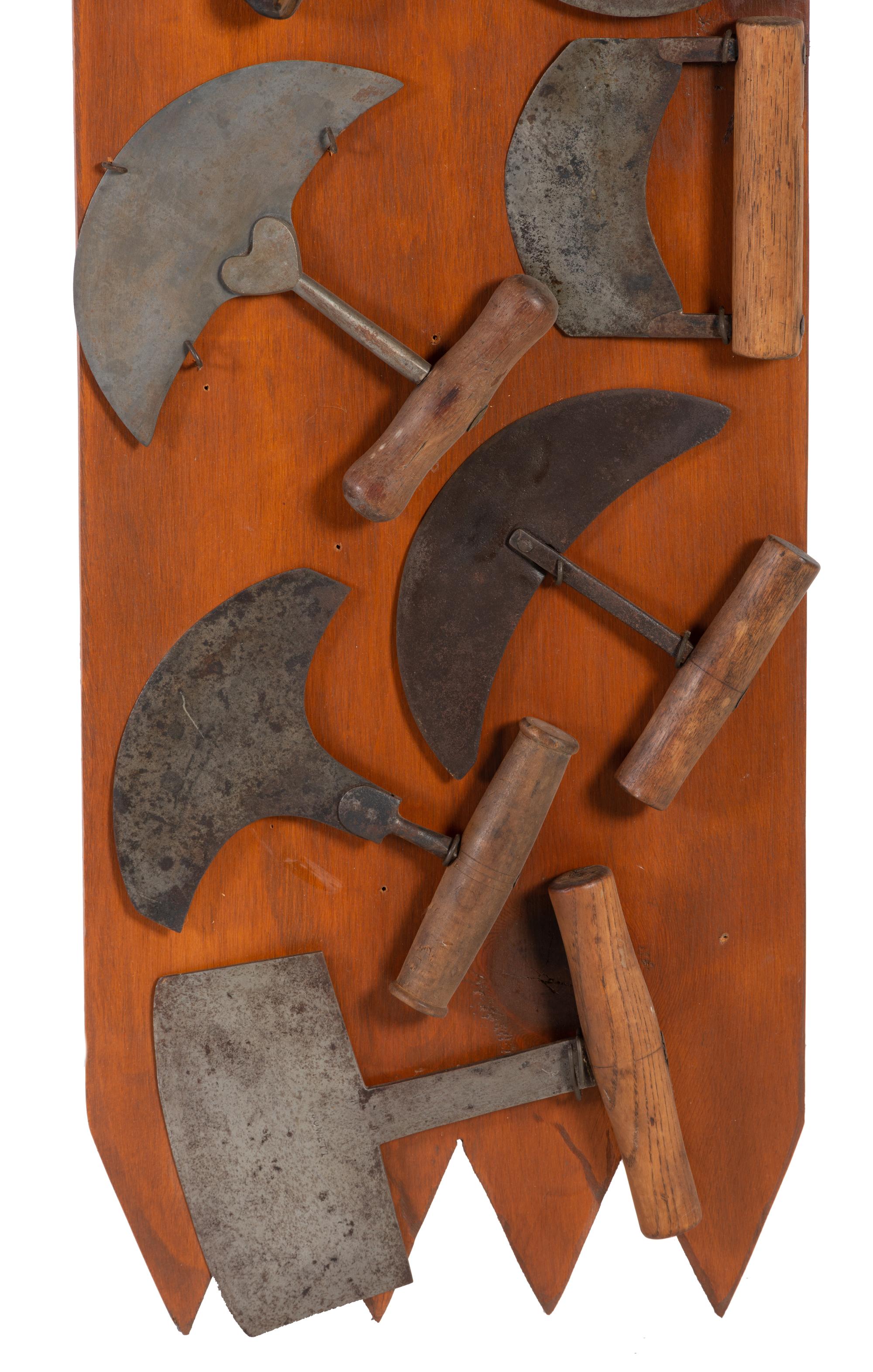 A Collection of Wrought Iron Kitchen Tools Mounted to Panel