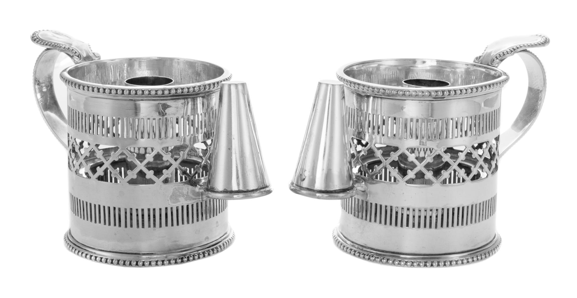 A Pair of English Silver-Plate Chambersticks, 19th Century, each formed as a mug with pierced sides.