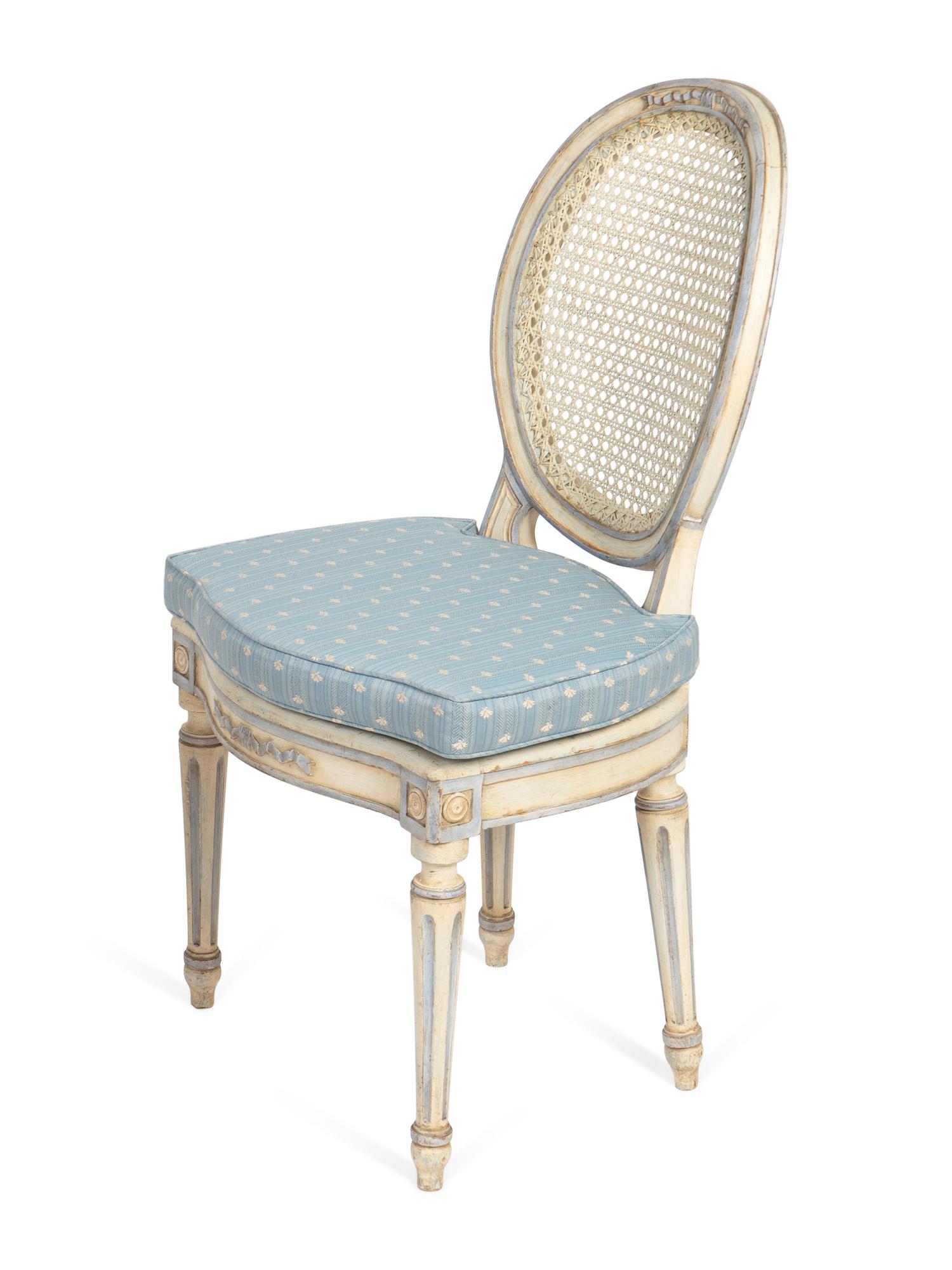 A Pair of Louis XVI Style White-Painted and Caned Chaises