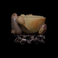 A Rare Chinese Yixing 'Peach and Pomegranate' Coupe Inscribed 'Chen Minyuan Zuo' and Carved Wood Stand 陳鳴遠款段泥紫砂桃榴杯