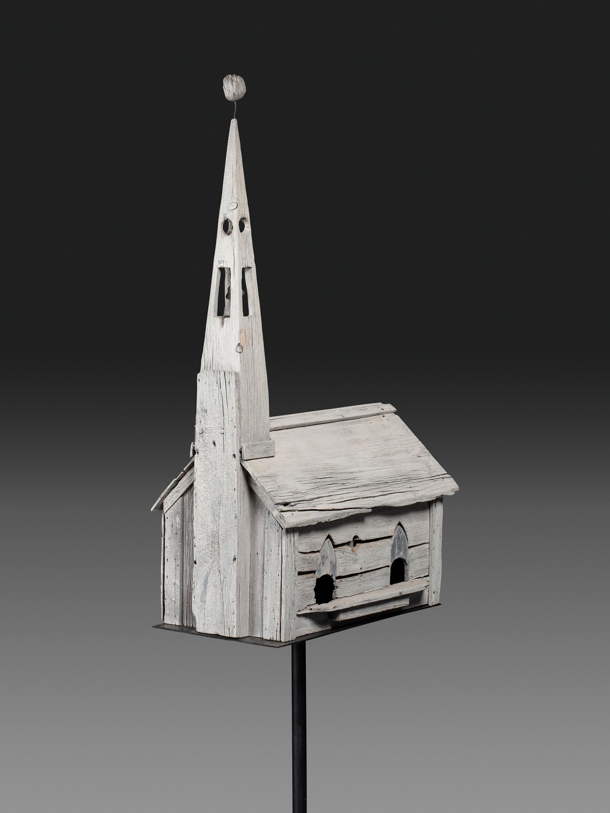 A Carved Wood Church Form Bird House on Stand