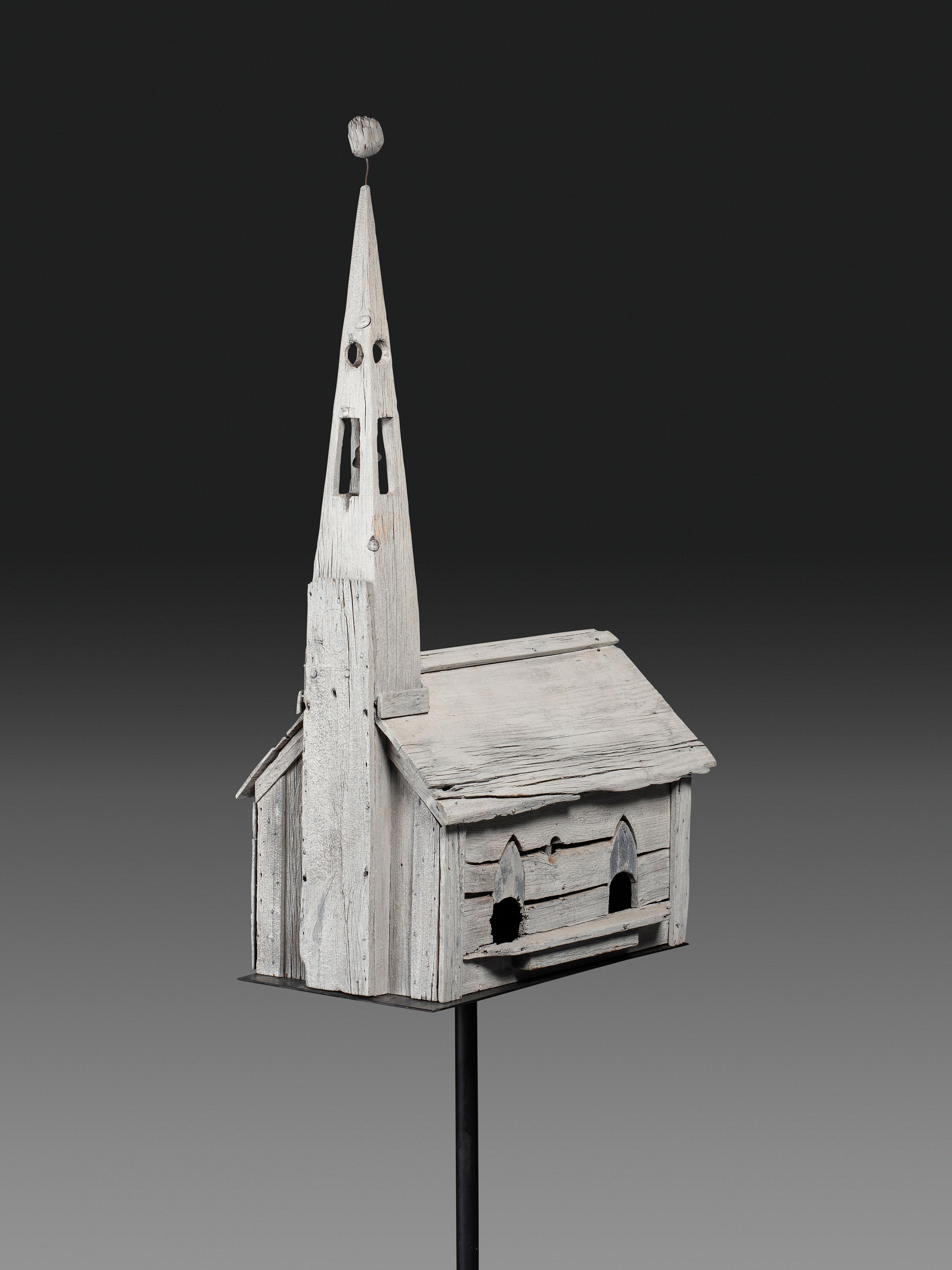 A Carved Wood Church Form Bird House on Stand