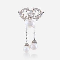 A natural pearl, diamond, eighteen karat gold, and platinum brooch