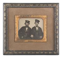 [EARLY PHOTOGRAPHY]. Occupational ambrotype of two men holding hands, possibly railroad conductors.