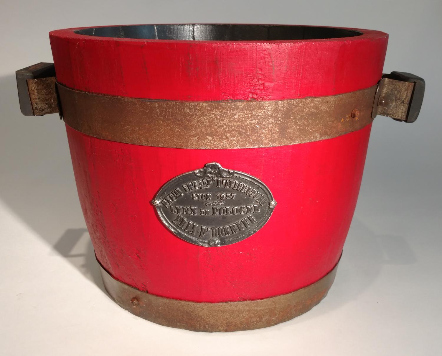 A Metal Mounted Red Painted Wood Planter Height 12 3/4 x diameter 15 3/4 inches.