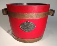 A Metal Mounted Red Painted Wood Planter Height 12 3/4 x diameter 15 3/4 inches.