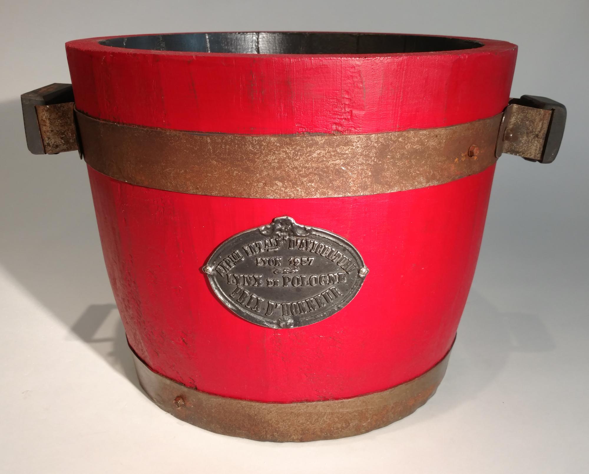 A Metal Mounted Red Painted Wood Planter Height 12 3/4 x diameter 15 3/4 inches.